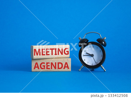 Meeting agenda symbol. Concept word Meeting agenda on wooden blocks. Beautiful blue background with alarm clock. Business and Meeting agenda concept. Copy space 133412508