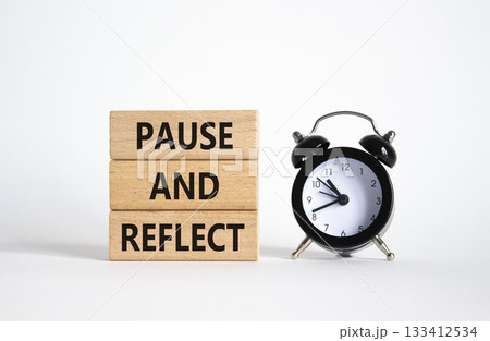 Pause and Reflect symbol. Concept words Pause and Reflect on wooden blocks. Beautiful white background with alarm clock. Business and Pause and Reflect concept. Copy space. 133412534