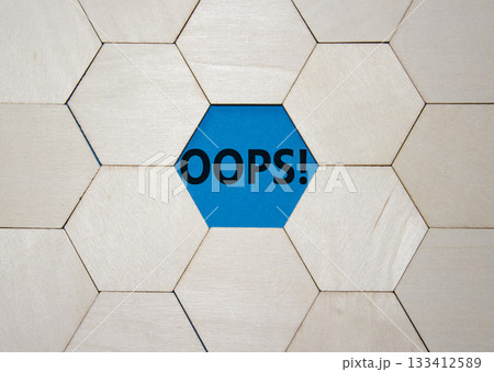 Oops symbol. Concept word Oops on wooden comb puzzle. Beautiful blue background. Business and Oops concept. Copy space. 133412589