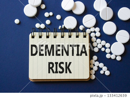 Dementia Risk symbol. Concept word Dementia Risk on notebook. Beautiful deep blue background with pills. Medicine and Dementia Risk concept. Copy space Dementia Risk symbol. Concept word Dementia Risk on notebook. Beautiful deep blue background with pills. Medicine and Dementia Risk concept. Copy space 133412639