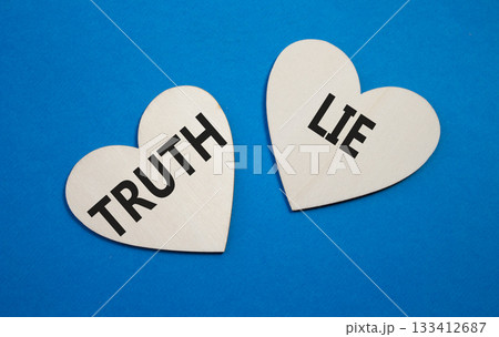 Truth or Lie symbol. Concept word Truth or Lie on wooden hearts. Beautiful blue background. Business and Truth or Lie concept. Copy space 133412687
