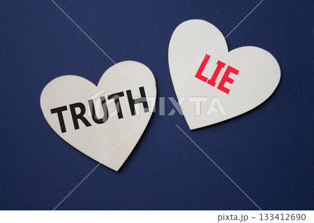 Truth or Lie symbol. Concept word Truth or Lie on wooden hearts. Beautiful deep blue background. Business and Truth or Lie concept. Copy space Truth or Lie symbol. Concept word Truth or Lie on wooden hearts. Beautiful deep blue background. Business and Truth or Lie concept. Copy space 133412690