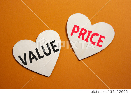 Price and Value symbol. Concept word Price and Value on wooden hearts. Beautiful orange background. Business and Price and Value concept. Copy space Price and Value symbol. Concept word Price and Value on wooden hearts. Beautiful orange background. Business and Price and Value concept. Copy space 133412693