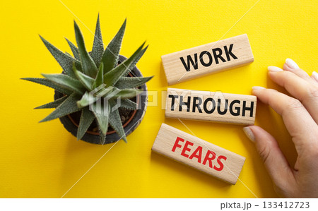 Work through fears. Wooden blocks with words Work through fears. Beautiful yellow background. Businessman hand. Business and Work through fears concept. Copy space. Work through fears. Wooden blocks with words Work through fears. Beautiful yellow background. Businessman hand. Business and Work through fears concept. Copy space. 133412723