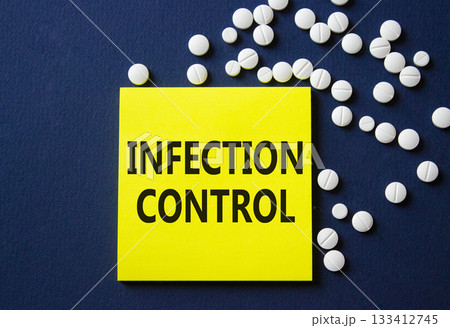 Infection Control symbol. Concept word Infection Control on yellow note. Beautiful deep blue background with pills. Medicine and Infection Control concept. Copy space Infection Control symbol. Concept word Infection Control on yellow note. Beautiful deep blue background with pills. Medicine and Infection Control concept. Copy space 133412745