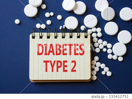 Diabetes Type 2 symbol. Concept word Diabetes Type 2 on notebook. Beautiful deep blue background with pills. Medicine and Diabetes Type 2 concept. Copy space Diabetes Type 2 symbol. Concept word Diabetes Type 2 on notebook. Beautiful deep blue background with pills. Medicine and Diabetes Type 2 concept. Copy space 133412751