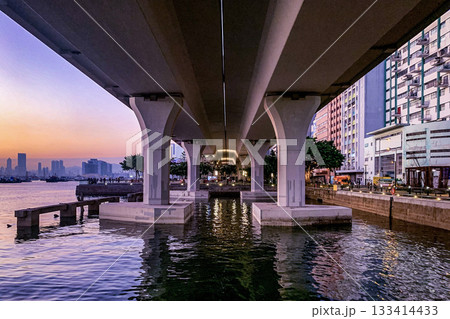 The underside of the bridge reveals a unique perspective of the urban landscape and the tranquil water below The underside of the bridge reveals a unique perspective of the urban landscape and the tranquil water below 133414433
