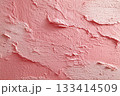 Textured pink wall surface with unique patterns and shades, ideal for background use. 133414509
