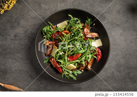 Fresh arugula salad with beef and sundried tomatoes Fresh arugula salad with beef and sundried tomatoes 133414556