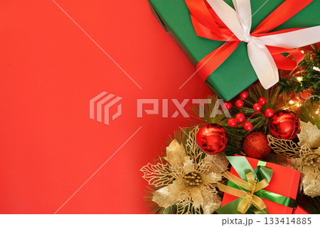 Christmas gifts and decorations on vibrant red background 133414885
