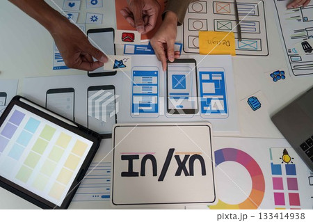 UI UX Design Collaboration. Team brainstorming and creating mobile app prototypes. 133414938
