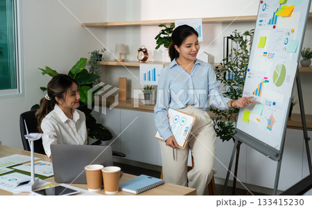 ESG Presentation. Businesswoman Explaining Data to Colleague in Office. ESG Presentation. Businesswoman Explaining Data to Colleague in Office. 133415230