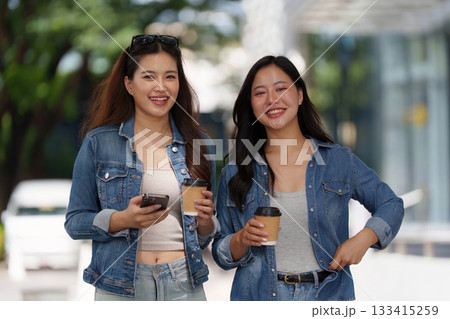 Friendship Moment. Two women enjoying coffee together outdoors. Friendship Moment. Two women enjoying coffee together outdoors. 133415259