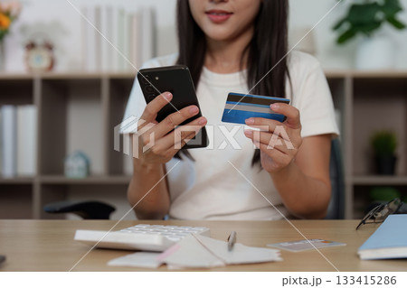 Payment Process. Woman holding credit card and smartphone for online shopping. Payment Process. Woman holding credit card and smartphone for online shopping. 133415286