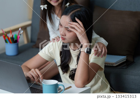 Stressful Study Session. Young woman feeling overwhelmed while studying at home. Stressful Study Session. Young woman feeling overwhelmed while studying at home. 133415313