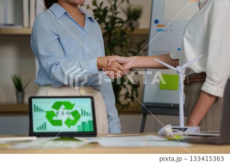 ESG Partnership. Business professionals shaking hands over sustainability goals. ESG Partnership. Business professionals shaking hands over sustainability goals. 133415363