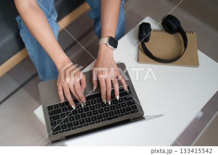 Remote Work. Close-up of woman typing on laptop. Remote Work. Close-up of woman typing on laptop. 133415542