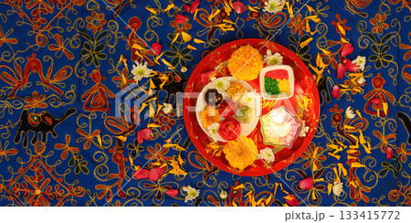 Diwali celebration. Decorative items arranged on vibrant rangoli. 133415772