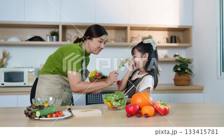 Healthy Eating. Mother teaching daughter about fresh vegetables in modern kitchen. Healthy Eating. Mother teaching daughter about fresh vegetables in modern kitchen. 133415781