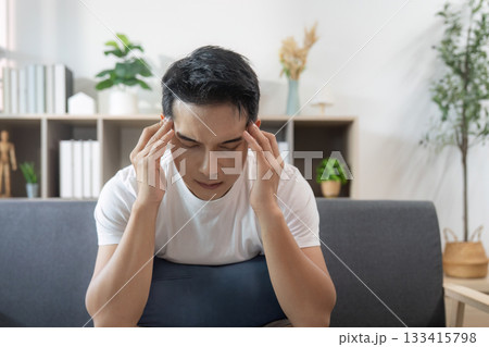 Emotional struggle. Young man dealing with stress and anxiety at home. Emotional struggle. Young man dealing with stress and anxiety at home. 133415798