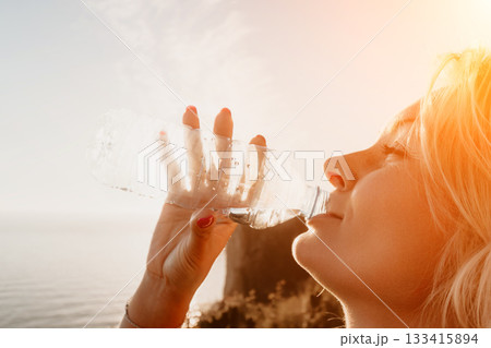 Woman Refreshing with Water on a Sunny Day 133415894