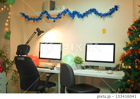 Cheerful office desk with computer and festive Christmas holiday decoration. 133416041