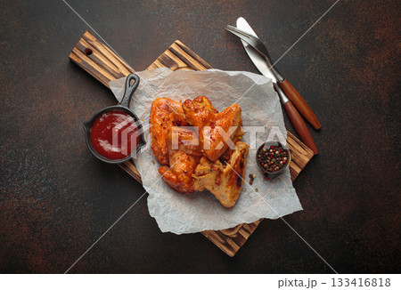 Roasted grilled chicken wings dipping sauce ketchup wooden cutting board barbecue bbq Roasted grilled chicken wings dipping sauce ketchup wooden cutting board barbecue bbq 133416818