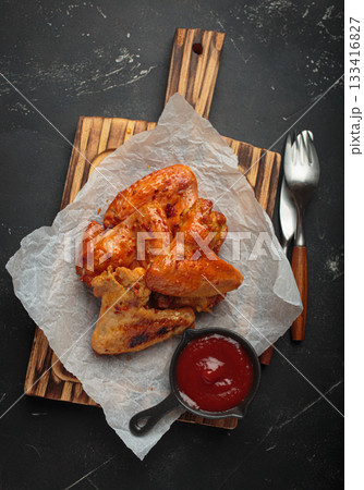 Roasted grilled chicken wings dipping sauce ketchup wooden cutting board barbecue bbq Roasted grilled chicken wings dipping sauce ketchup wooden cutting board barbecue bbq 133416827