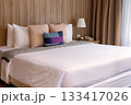 Luxurious Bedroom with Comfortable Bed, Stylish Furniture, and Soft Pillows in a Cozy Home Setting 133417026