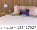 Luxurious Bedroom with Comfortable Bed, Stylish Furniture, and Soft Pillows in a Cozy Home Setting 133417027