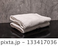 A clean stack of white folded towels in the bathroom 133417036