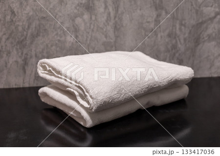 A clean stack of white folded towels in the bathroom A clean stack of white folded towels in the bathroom 133417036