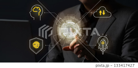 Businessman uses a futuristic digital interface displaying icons of AI, cloud computing, cybersecurity, and innovation, representing digital transformation and modern technology. 133417427