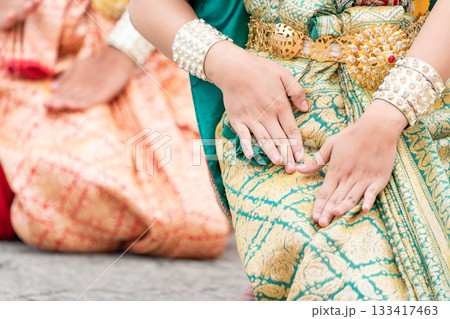 Close up hand of Thai folk dance during celebration on temple background. Thai traditional dance on event celebration. Close up hand of Thai folk dance during celebration on temple background. Thai traditional dance on event celebration. 133417463