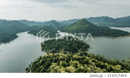 Kaeng Krachan dam with lake view and many green moutain, blue sky background. Kaeng Krachan Dam national park, Phetchaburi province, Thailand in aerial view from drone. 133417464