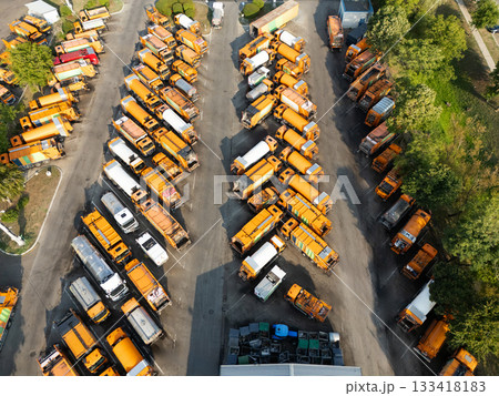 Fleet of yellow garbage trucks. Aerial view. Fleet of yellow garbage trucks. Aerial view. 133418183