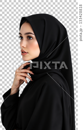 Woman Hijab Black. A young woman wearing a black hijab and abaya is seen in a profile view, looking 133428818