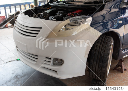 Checking car body work fiber bumper at car garage Checking car body work fiber bumper at car garage 133431984