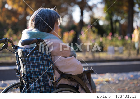 車椅子で外を見上げて微笑むシニア（高齢者）女性 133432313