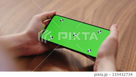 young woman holding smartphone over walnut table young woman holding smartphone over walnut table 133432734