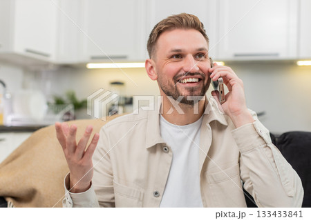 Young man talks with friend on smartphone gestures explains decision then warm goodbye friendly call 133433841