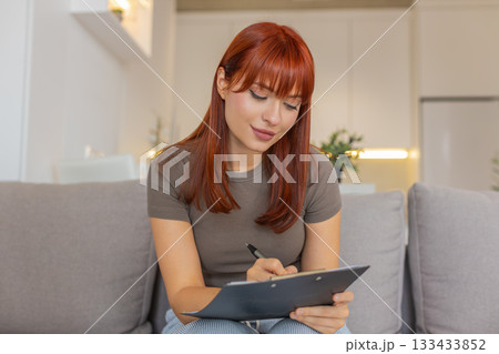 Young woman draws on paper makes sketch logo or illustration for work creative design process step 133433852