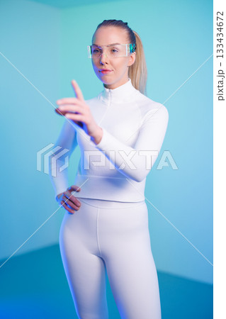 Female in smartglasses against blue background 133434672