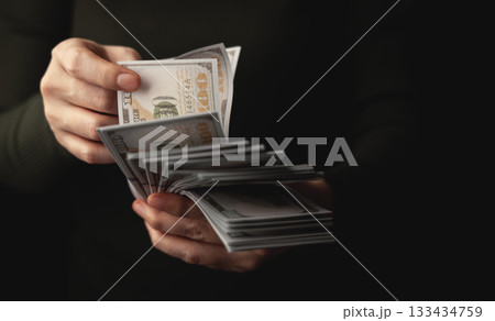 Hands counting US dollar banknote, symbolizing finance, payment, banking Hands counting US dollar banknote, symbolizing finance, payment, banking 133434759