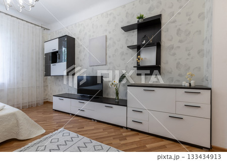Modern Living Bedroom Interior with TV and Black White Furniture Modern Living Bedroom Interior with TV and Black White Furniture 133434913