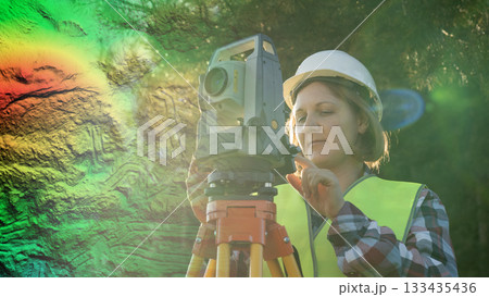 A female surveyor uses lidar technology for ultra-precise measurements and calculations in civil engineering. This involves the use of laser scanning technology to create highly accurate aerial 133435436