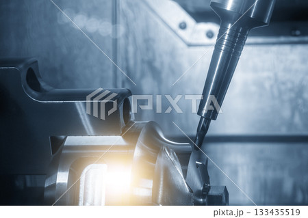The 5-axis CNC milling machine cutting the automotive part with solid ball nose end mill tool with lighting effect. The 5-axis CNC milling machine cutting the automotive part with solid ball nose end mill tool with lighting effect. 133435519