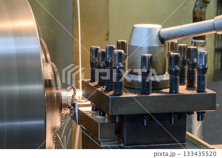 Close up scene the lathe machine finish cut metal shaft parts with liquid coolant method. Close up scene the lathe machine finish cut metal shaft parts with liquid coolant method. 133435520