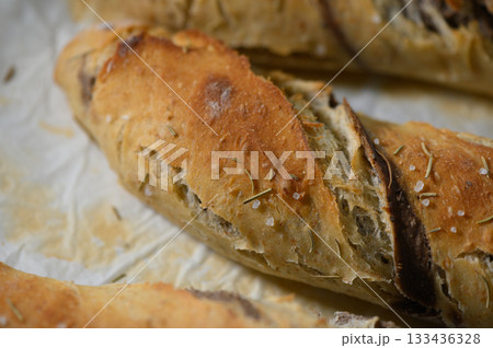 Freshly baked artisan bread with crispy crust and fragrant herbs brings warmth to any kitchen during a cozy afternoon Freshly baked artisan bread with crispy crust and fragrant herbs brings warmth to any kitchen during a cozy afternoon 133436328