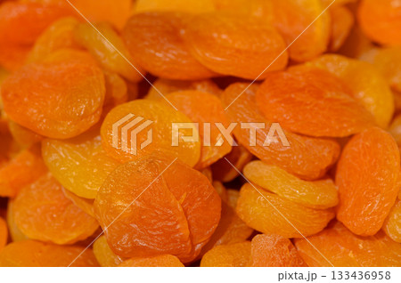Dried apricots arranged in a colorful display showcasing their vibrant hues and natural texture during an artisanal market event 133436958